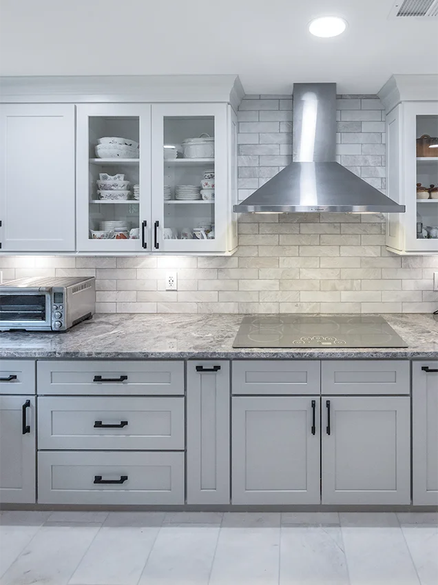 Elegant full kitchen remodel in Alexandria, VA, featuring white custom cabinetry and a spacious kitchen island.