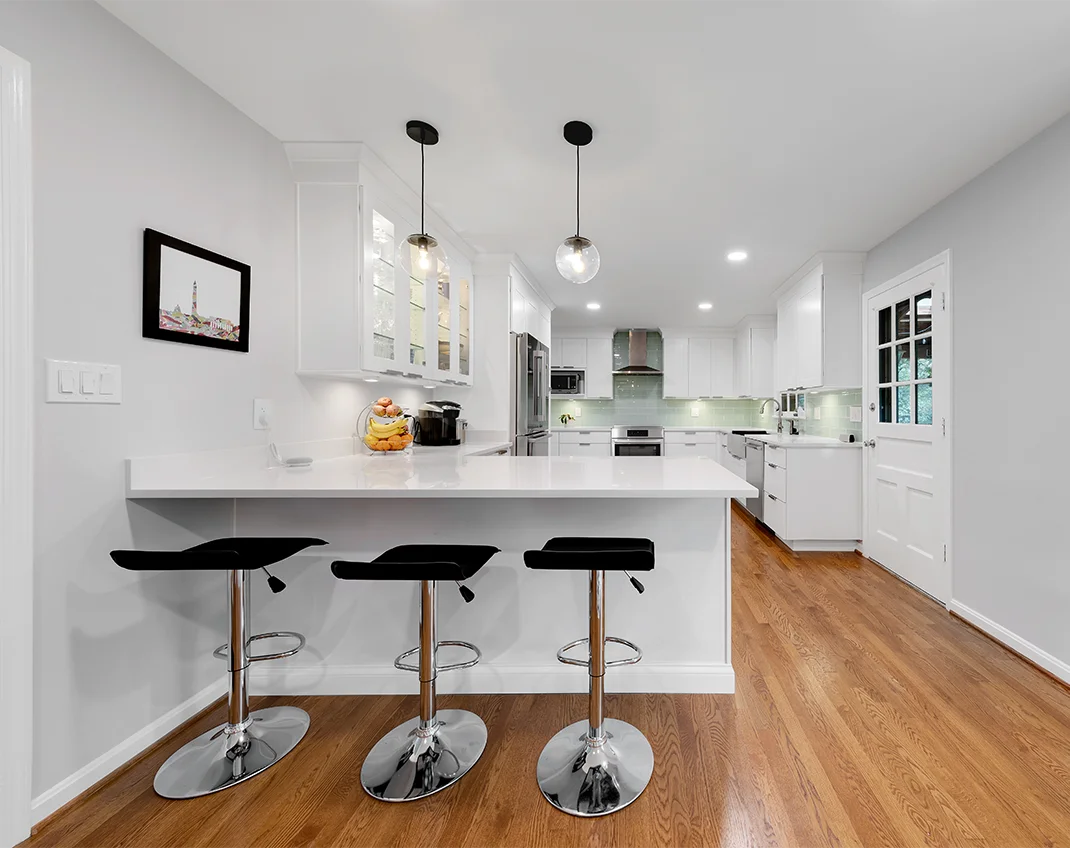 Modern kitchen renovation with sleek kitchen cabinets, marble countertops, and bright lighting in Northern VA.