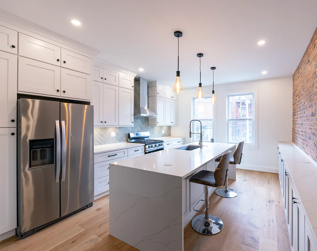 Upgraded kitchen design in Northern VA featuring polished stone countertops, stainless steel appliances, and ample storage.