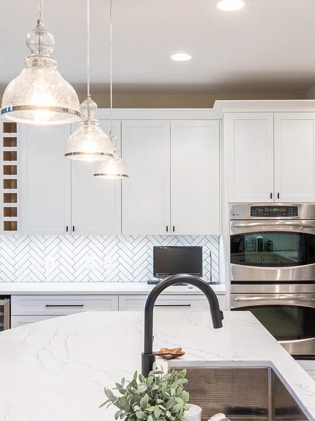 Fresh kitchen renovation with light-toned kitchen cabinets, sleek hardware, and a modern tile floor in Maryland.