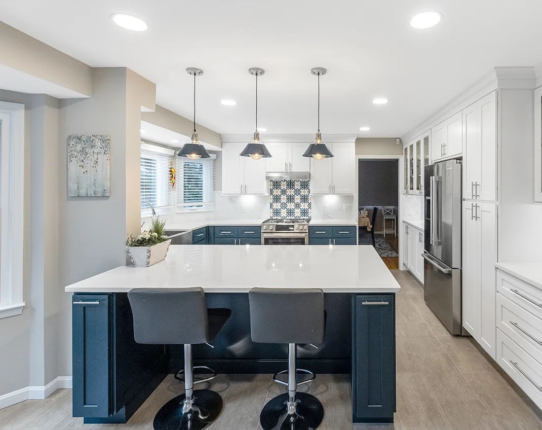 Bright and airy kitchen redesign showcasing white cabinetry, a large kitchen island, and minimalist décor in Alexandria, VA.